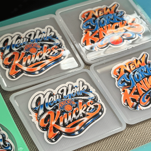 A variety of custom hand-poured resin coasters showing different designs including sports teams, college logos, and custom artwork made in Raleigh, NC.